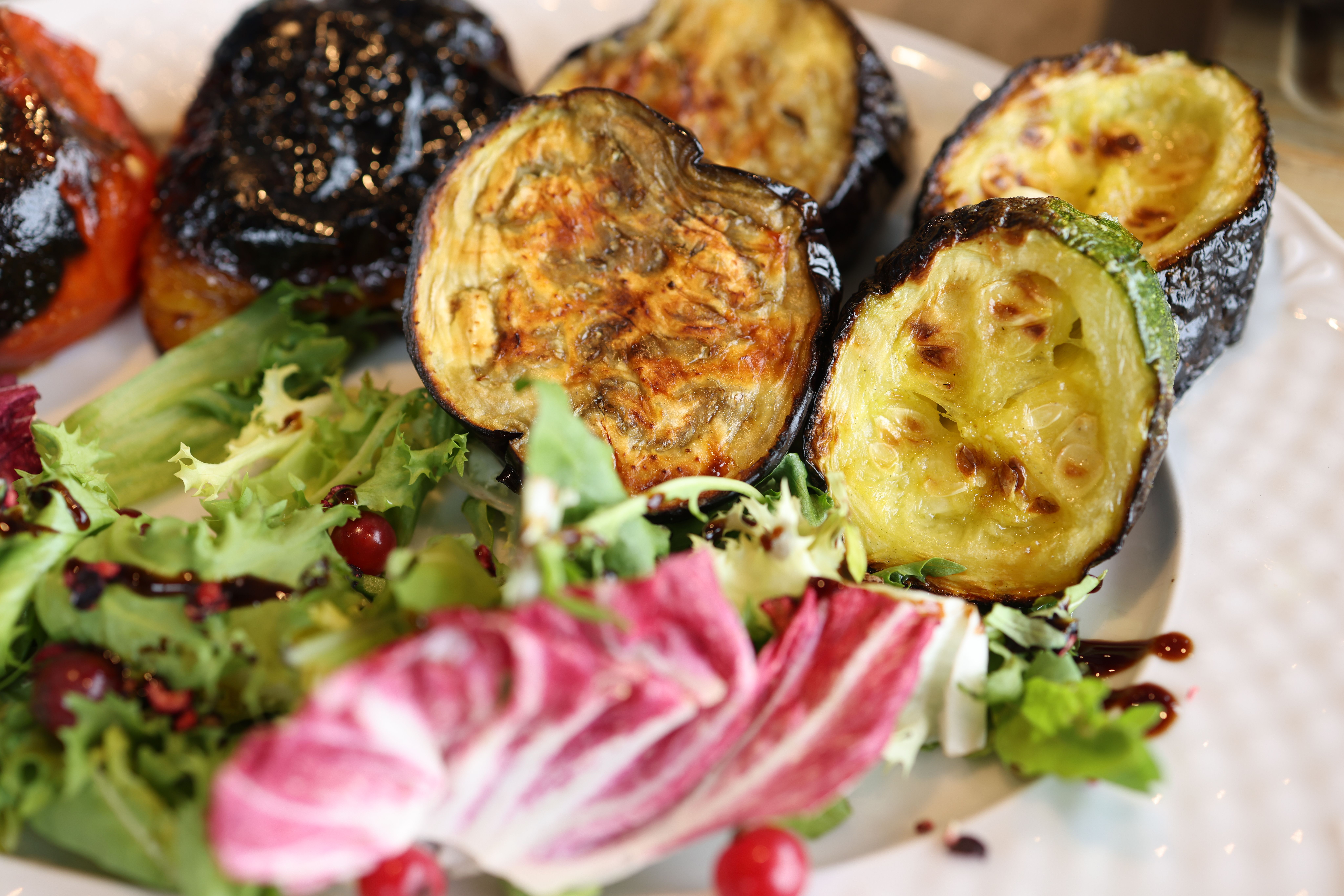 Grilled vegetables with dark caramelized balsamic glaze on a platter