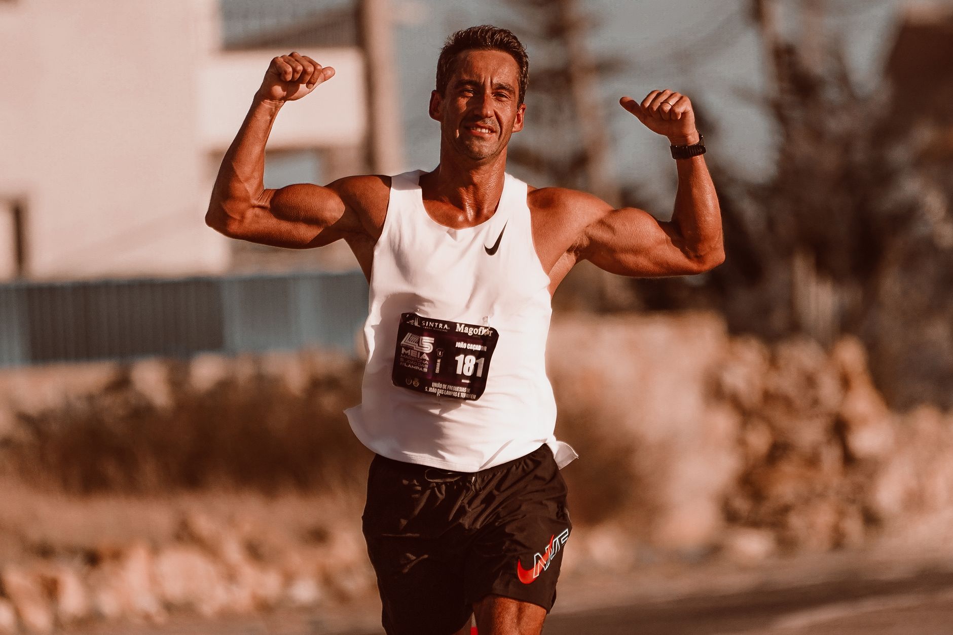 Runner on a Track with His Arms Raised a Gesture of Victory