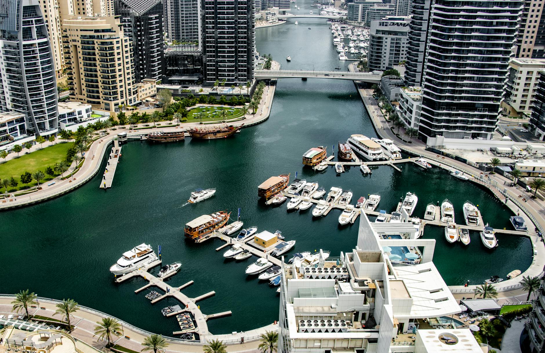 Stunning birds-eye view of Dubai Marina showcasing yachts and modern skyscrapers along the canal.