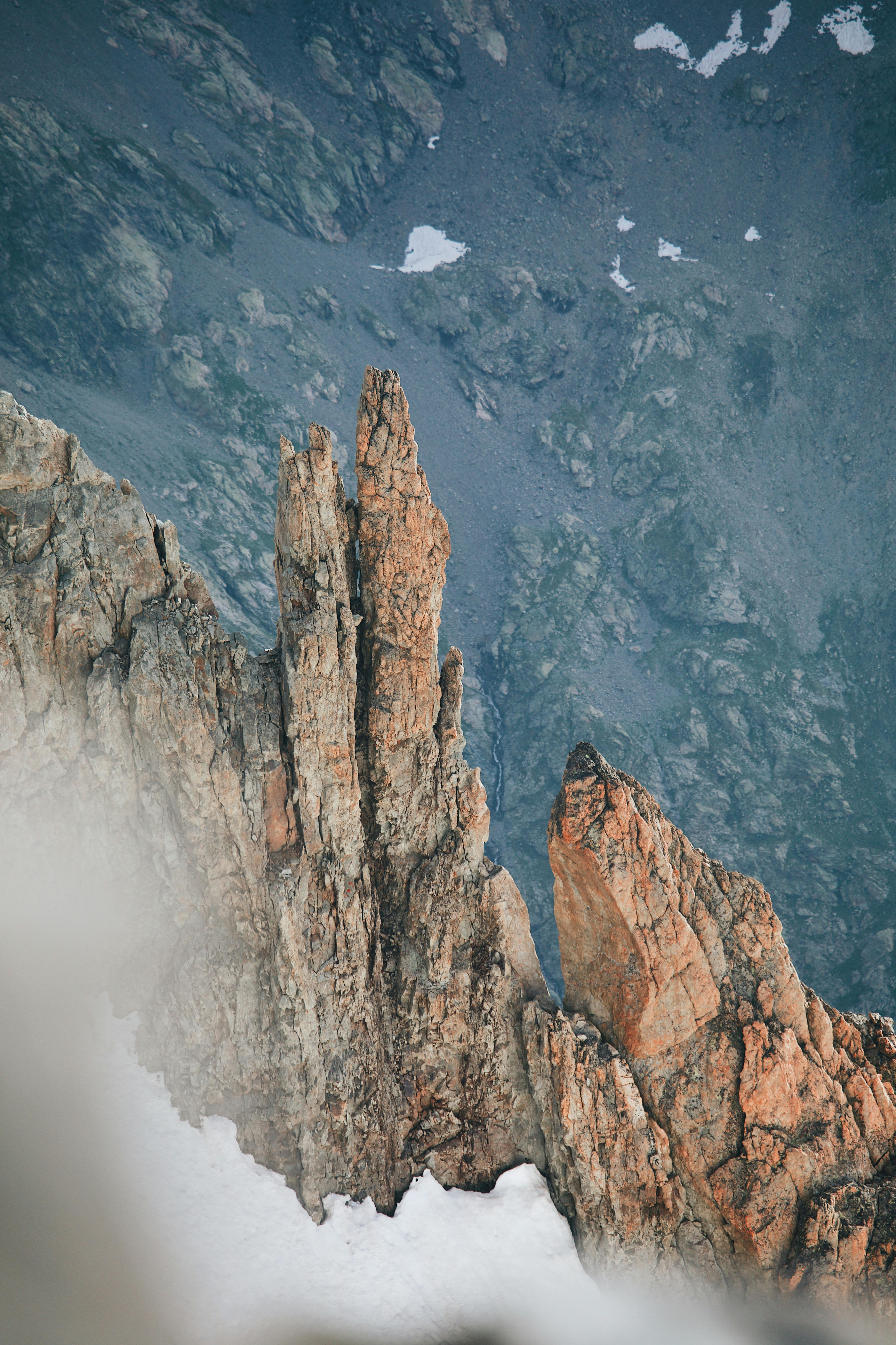 Prescription Goggle Inserts - A towering rock formation dusted with snow, showcasing stunning geology from above.