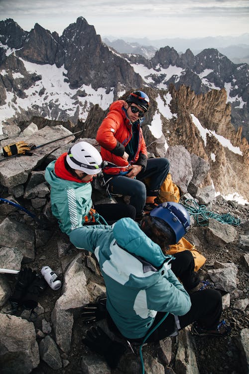 A group of people sitting on top of a mountain