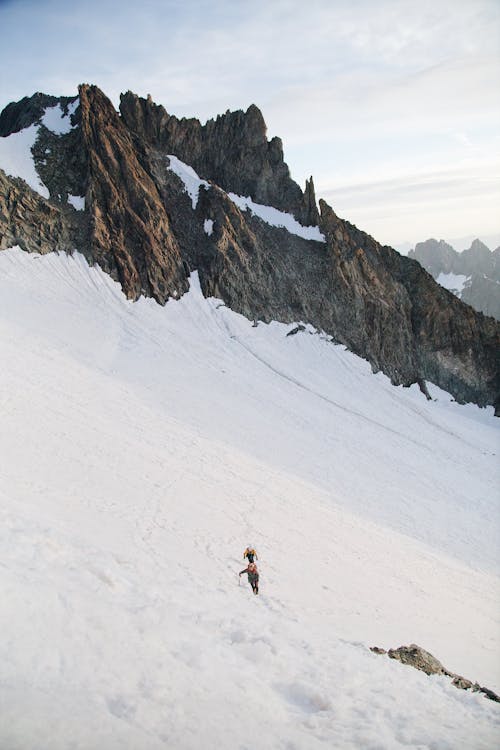 A person walking up a snowy mountain