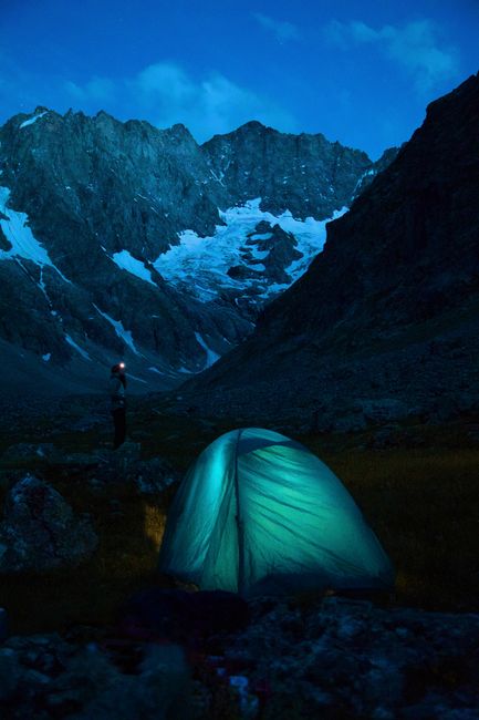 Experience the tranquility of a night camp in the French Alps with stunning mountain views.