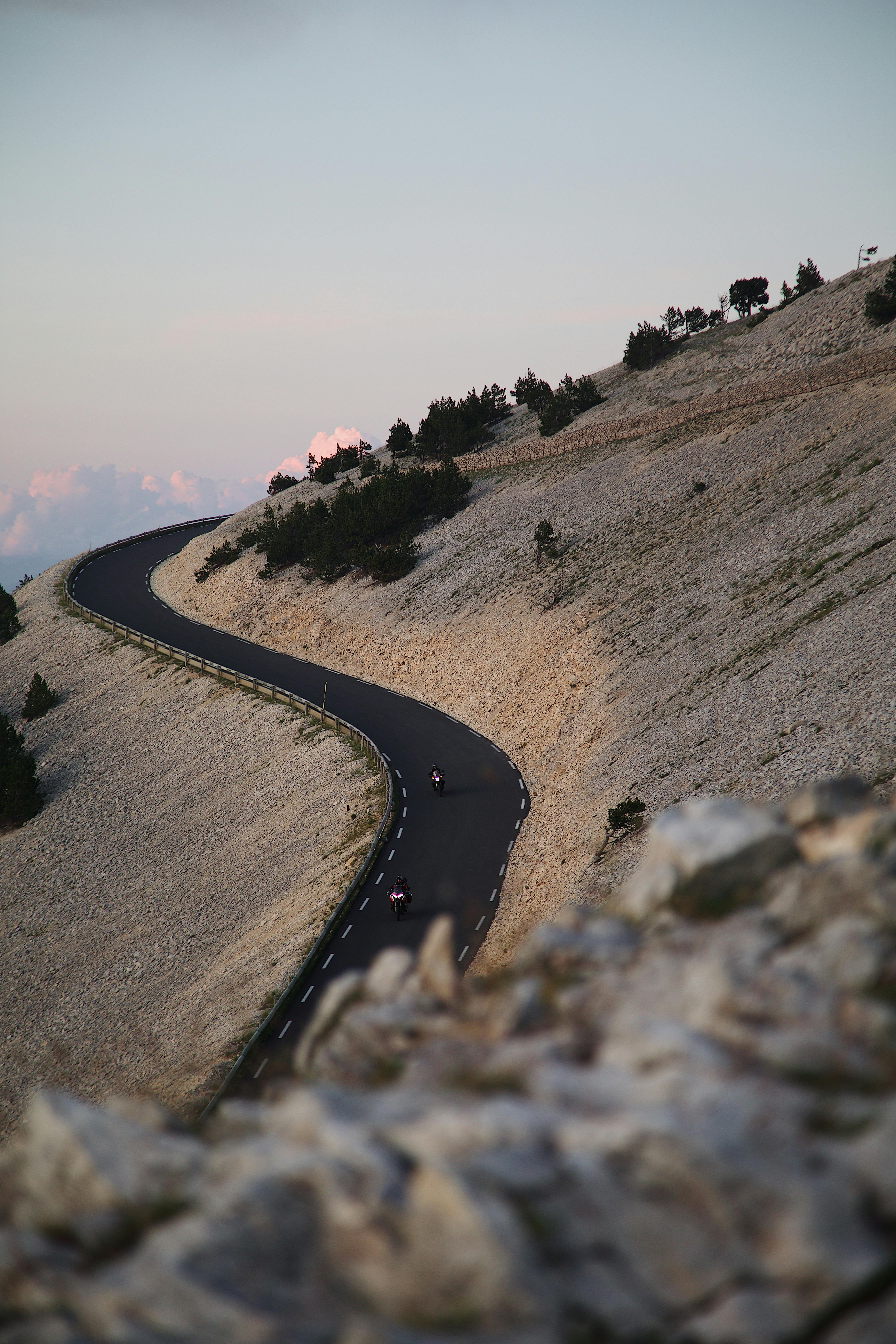 Scenic view of a winding road on Mont Ventoux, Provence at sunset, showcasing the mountainous landscape.