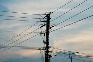 High-voltage transmission lines at dusk — photo by Andy Lee on Pexels