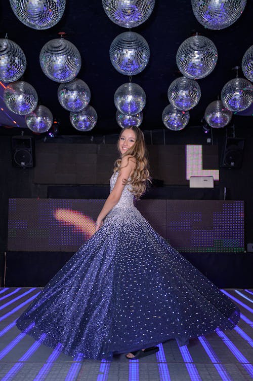 Young Woman in a Ball Dress Posing and Smiling 