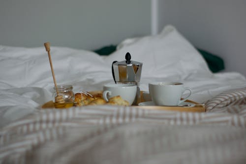Free Breakfast and Coffee on a Tray in Bed Stock Photo