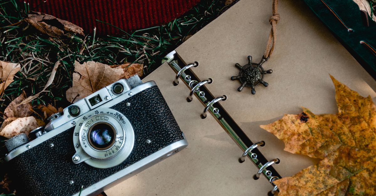 Camera Notepad Analog Camera on Open Notebook · Free Stock Photo