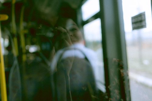 Free Creative reflection of photographer in a bus window, capturing a unique travel moment. Stock Photo