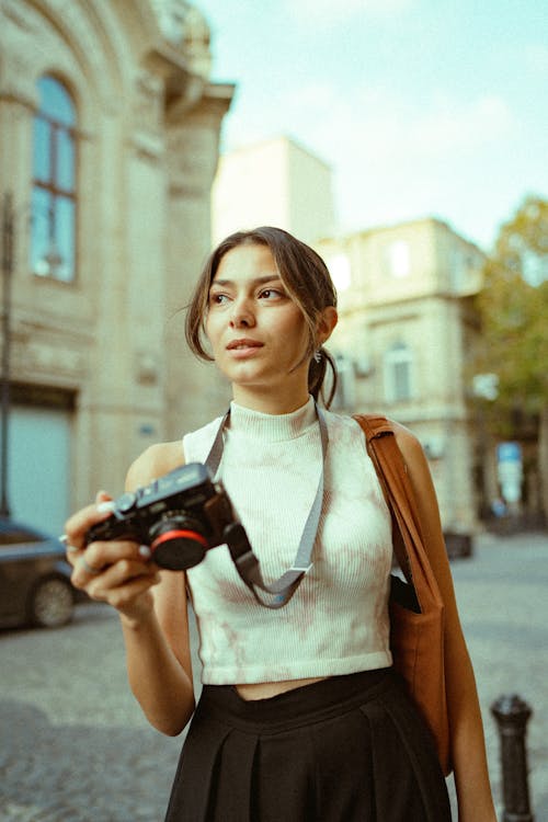 Woman in Turtleneck Top Holding Camera