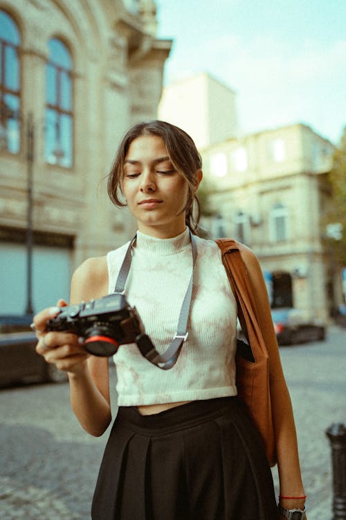 Woman Looking on Viewfinder on Digital Camera