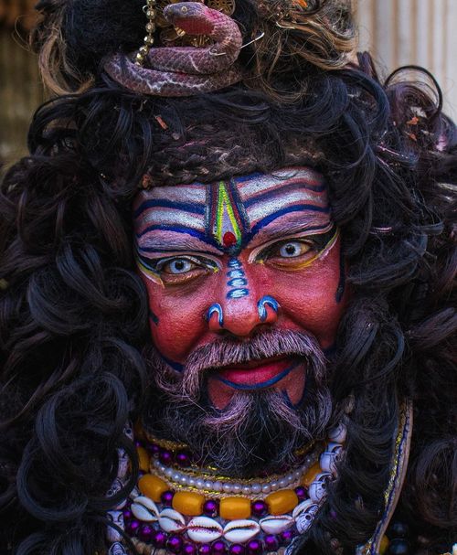 Free A vividly painted face and elaborate costume representing traditional Indian culture. Stock Photo
