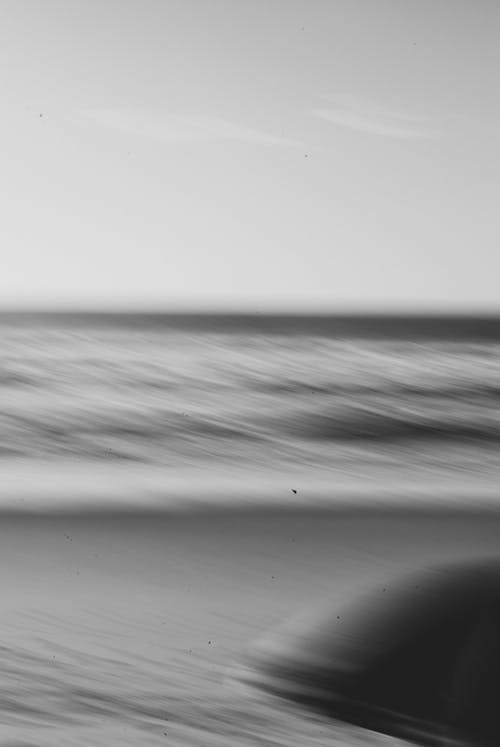 Blurred Photo of the Sea Hitting the Beach