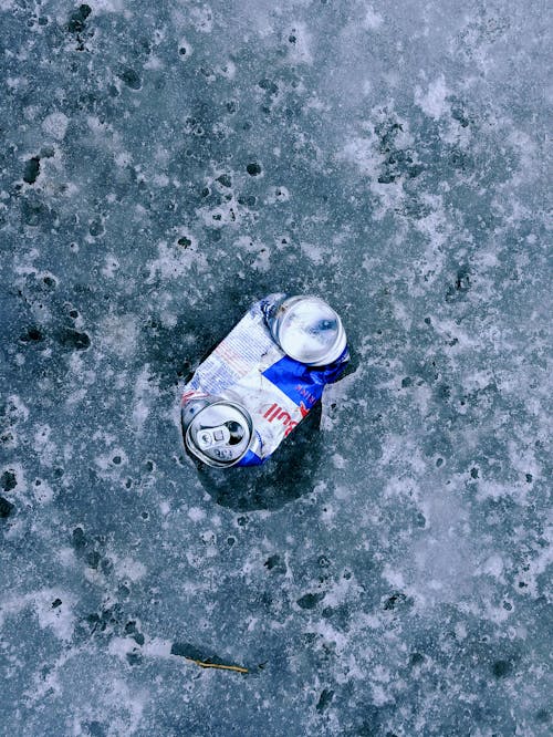 A Squashed Can on an Icy Ground