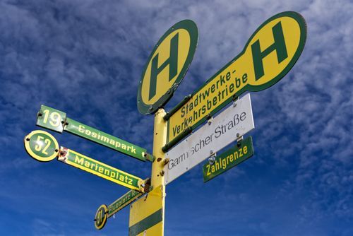 Free Low angle view of a city bus stop signpost against a vivid blue sky. Stock Photo