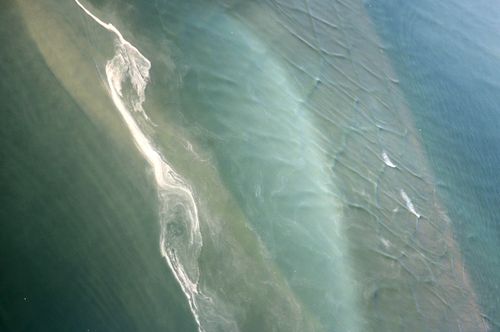 Free Aerial shot of water patterns near Le Mont-Saint-Michel, France, showcasing natural textures. Stock Photo