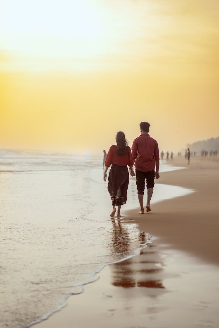 Couple Walking On The Beach Holding Hand