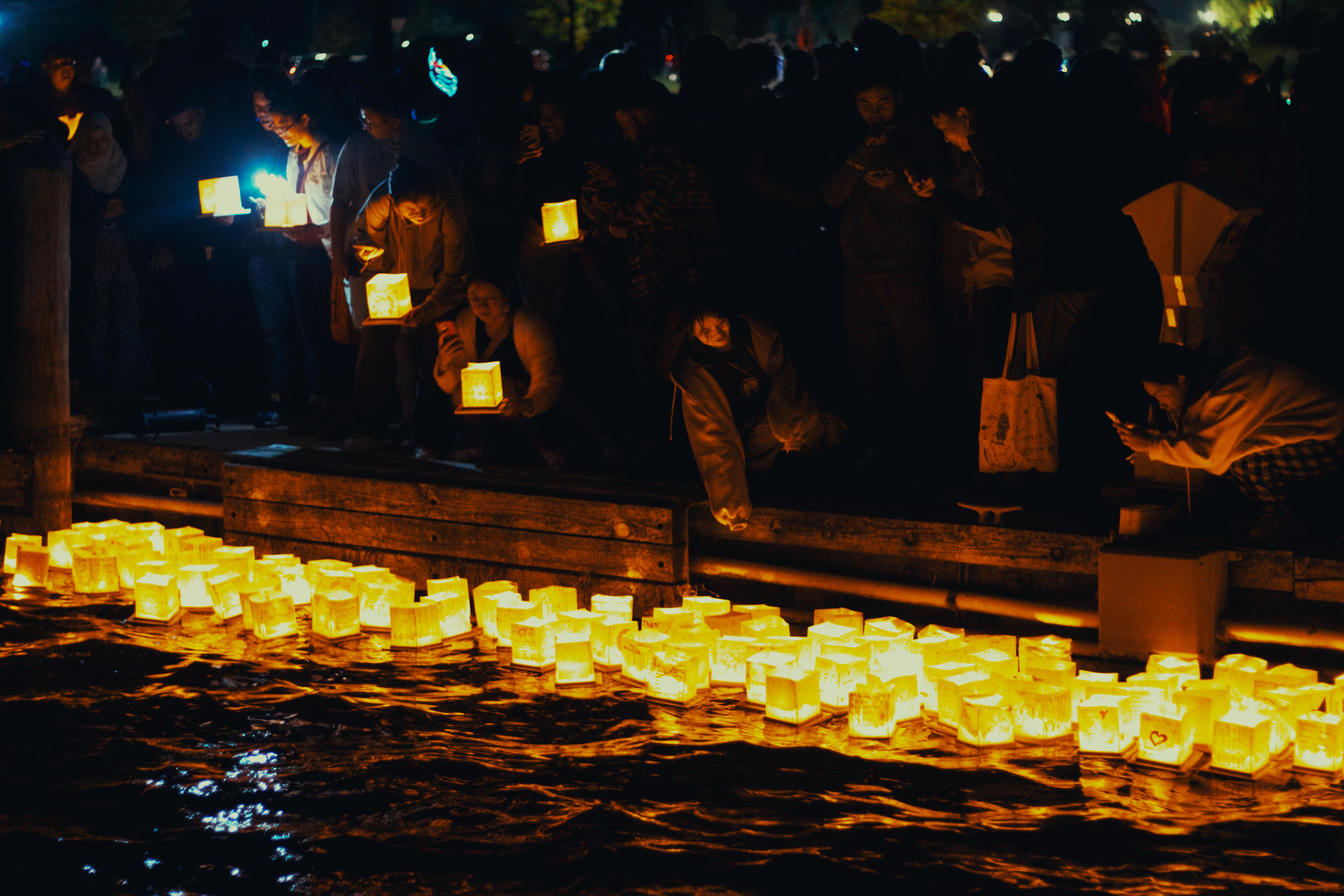 A serene night scene of floating lanterns during a festival in Saint Clair, Michigan.