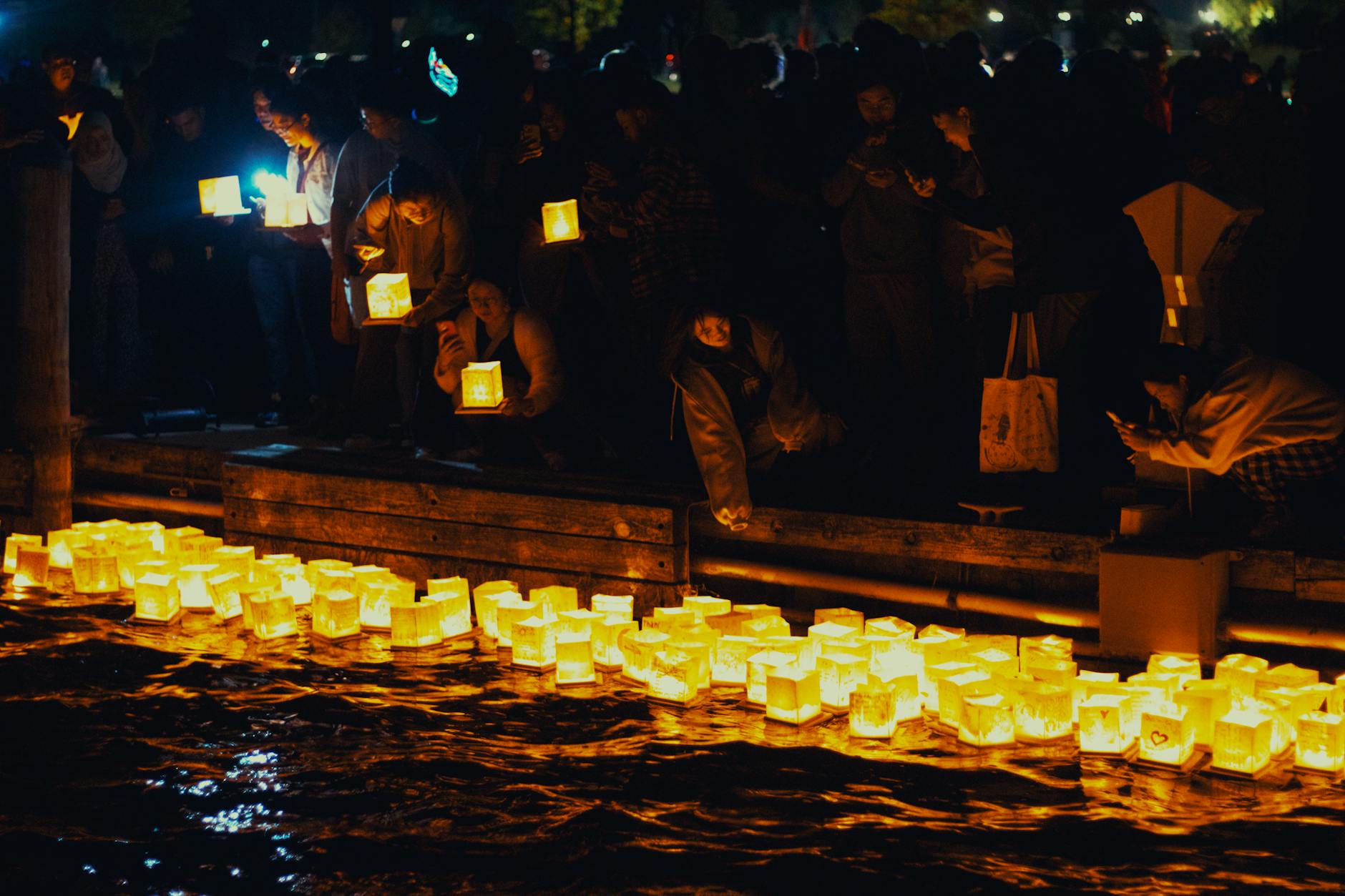 A serene night scene of floating lanterns during a festival in Saint Clair, Michigan.