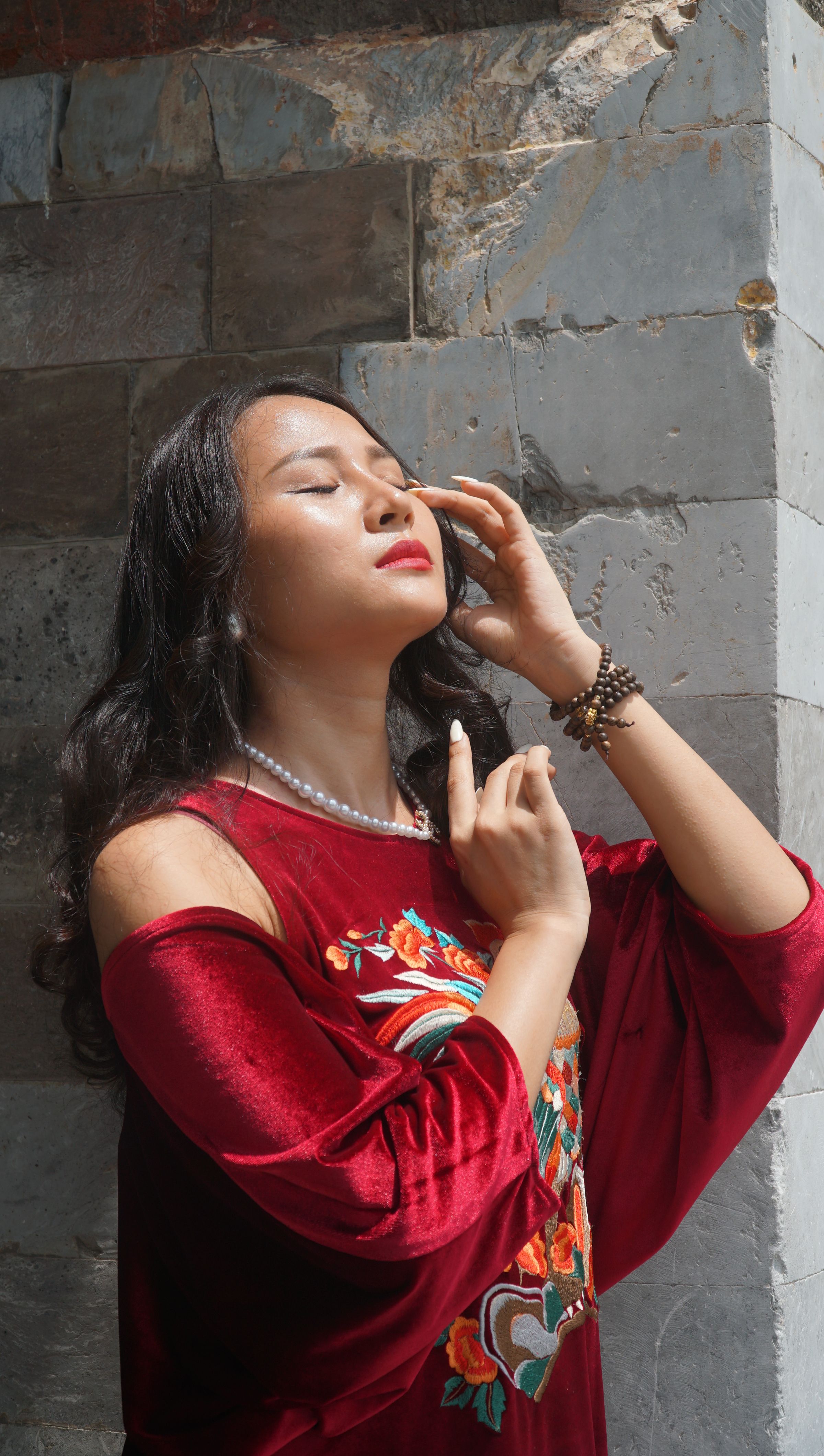 Young Woman in a Red Dress Posing Outside · Free Stock Photo