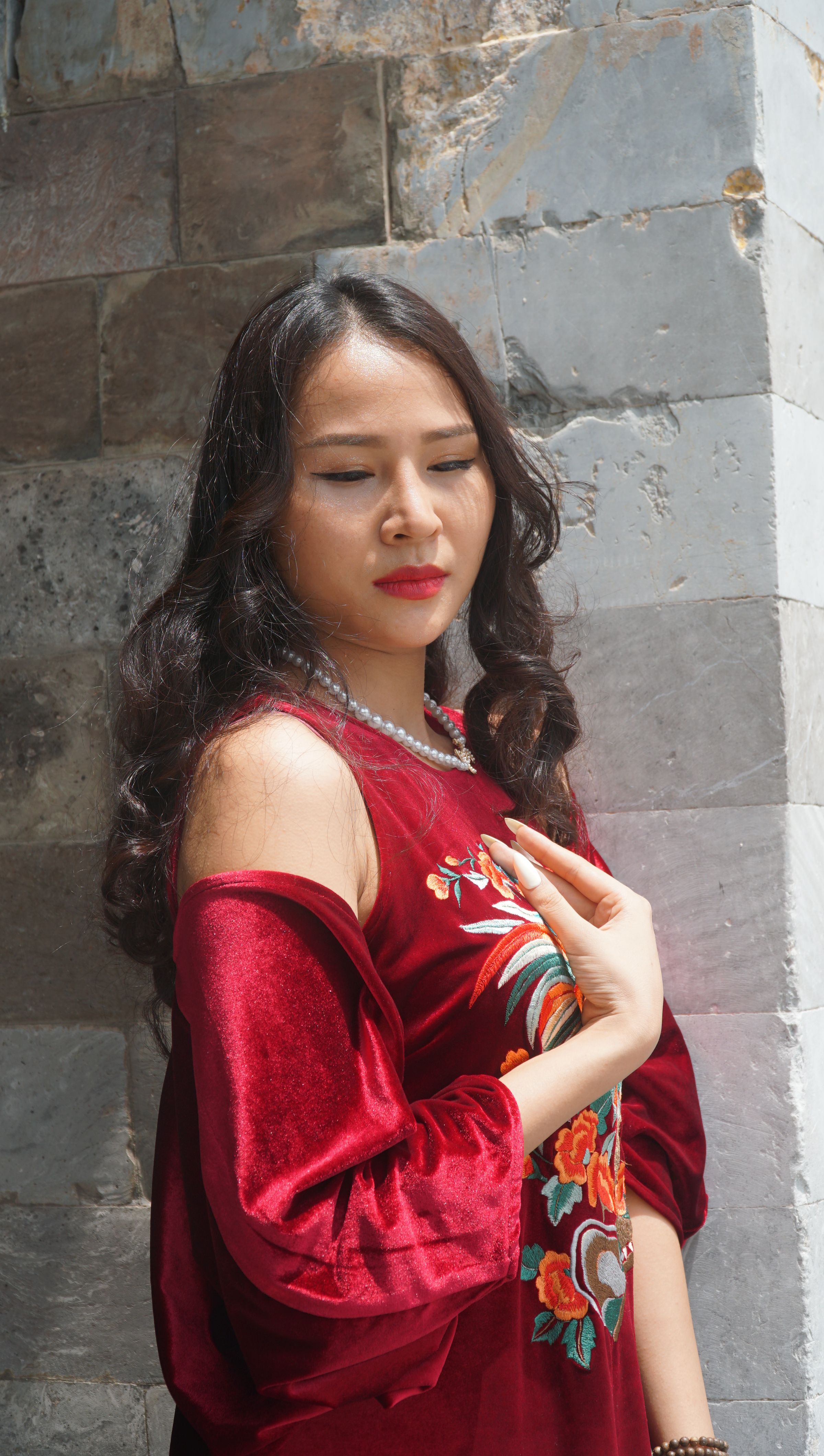 Young Woman in a Red Dress Posing Outside · Free Stock Photo