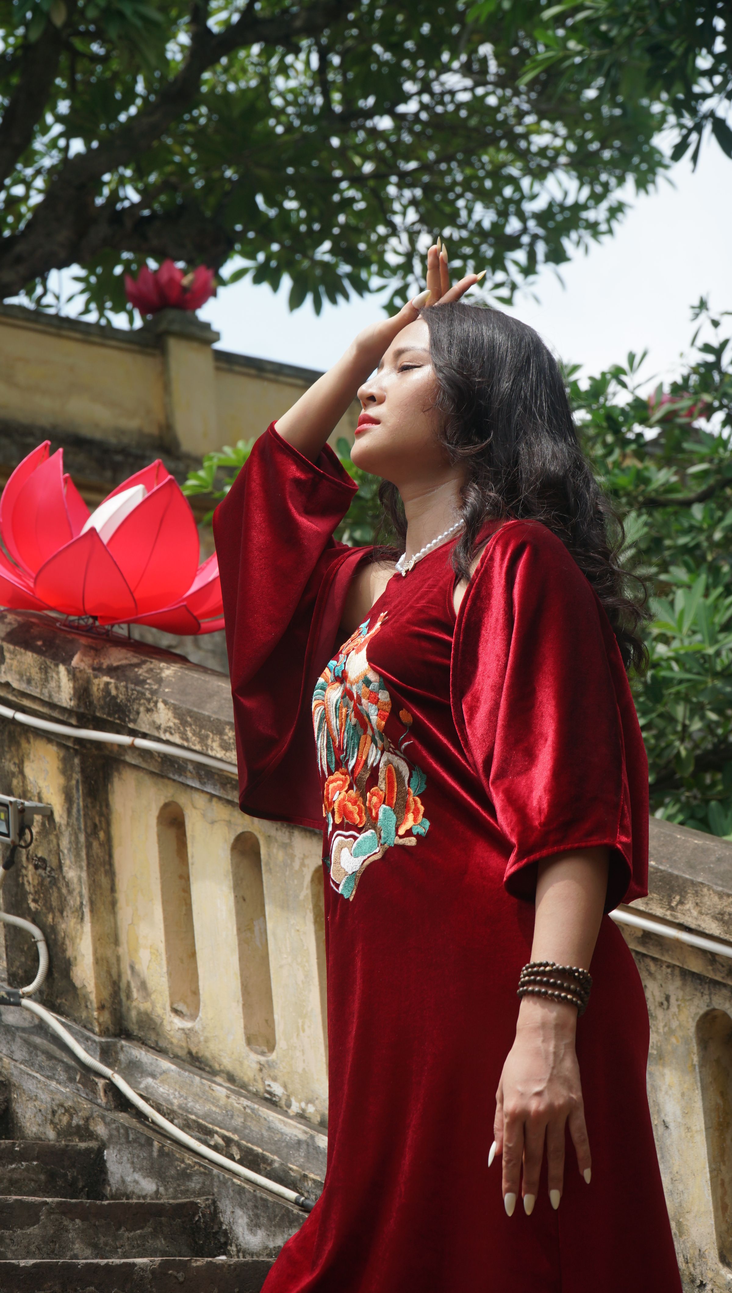 Woman in Red Velvet Dress Posing on Stairs · Free Stock Photo