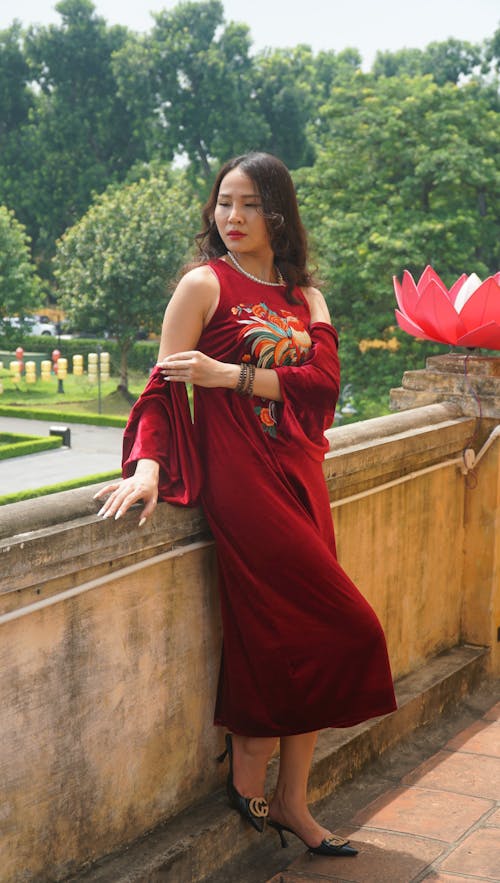 Woman in a Red Dress with an Embroidered Pattern on Terrace