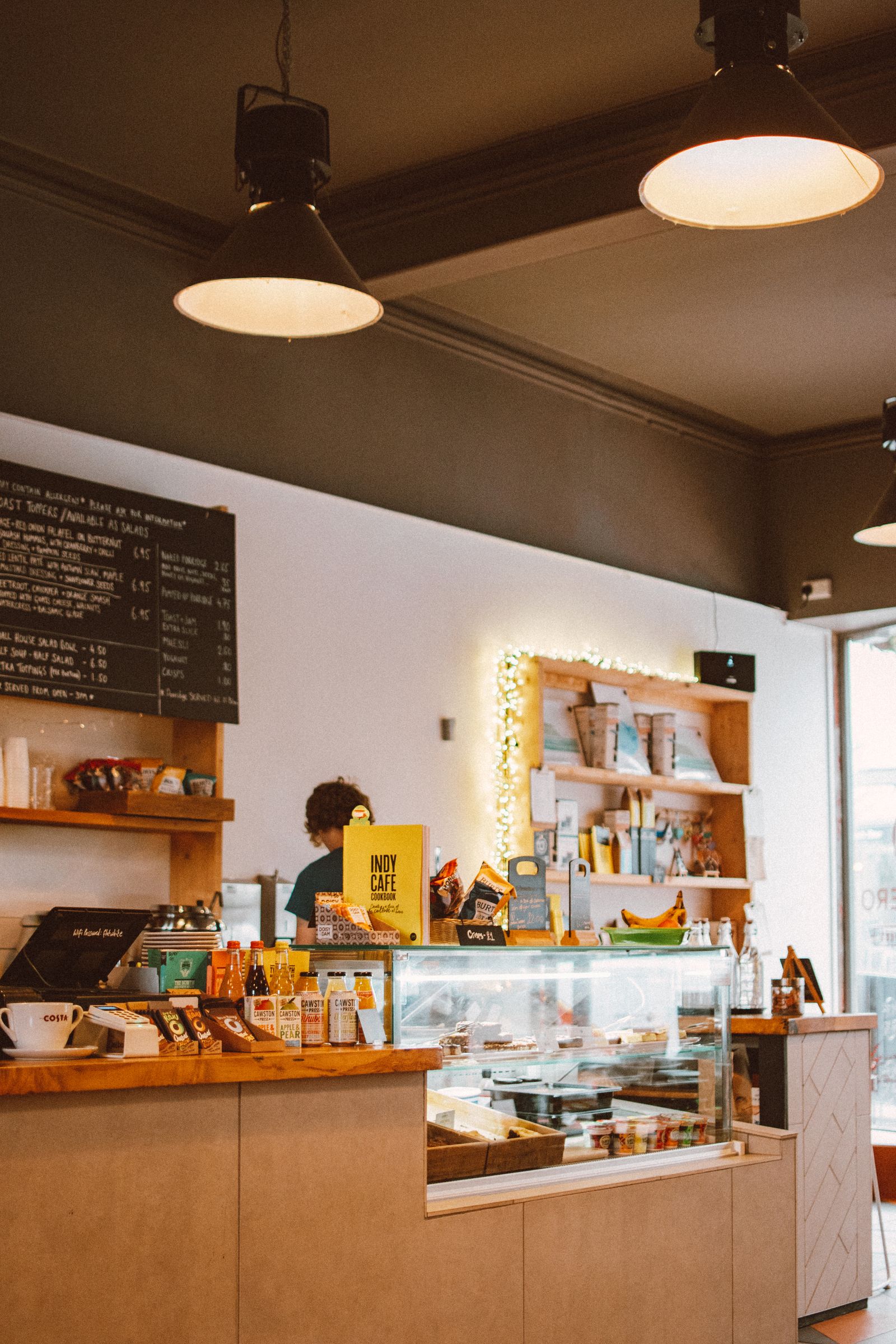 Small café interior with a service counter and food display