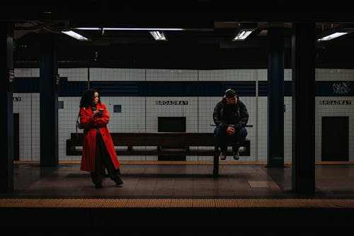 Woman and Man Waiting for Subway Train at Broadway Station, New York City, USA