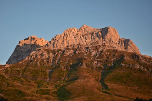 View of a Rocky Mountain under a Clear Blue Sky 