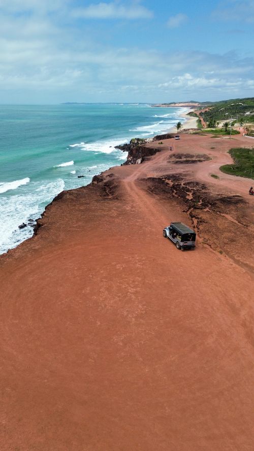 Free Drone shot capturing the stunning cliffs and shoreline in Praia da Pipa, Brazil. Stock Photo