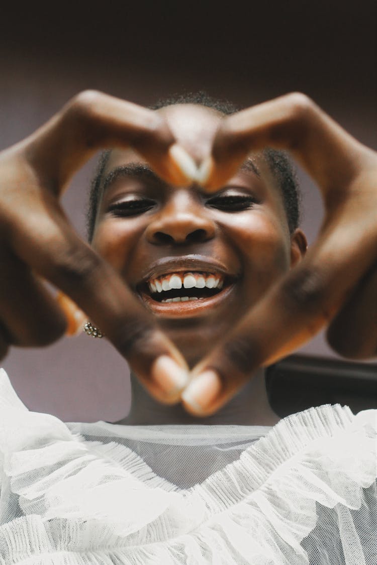 Smiling Woman Showing Heart Gesture