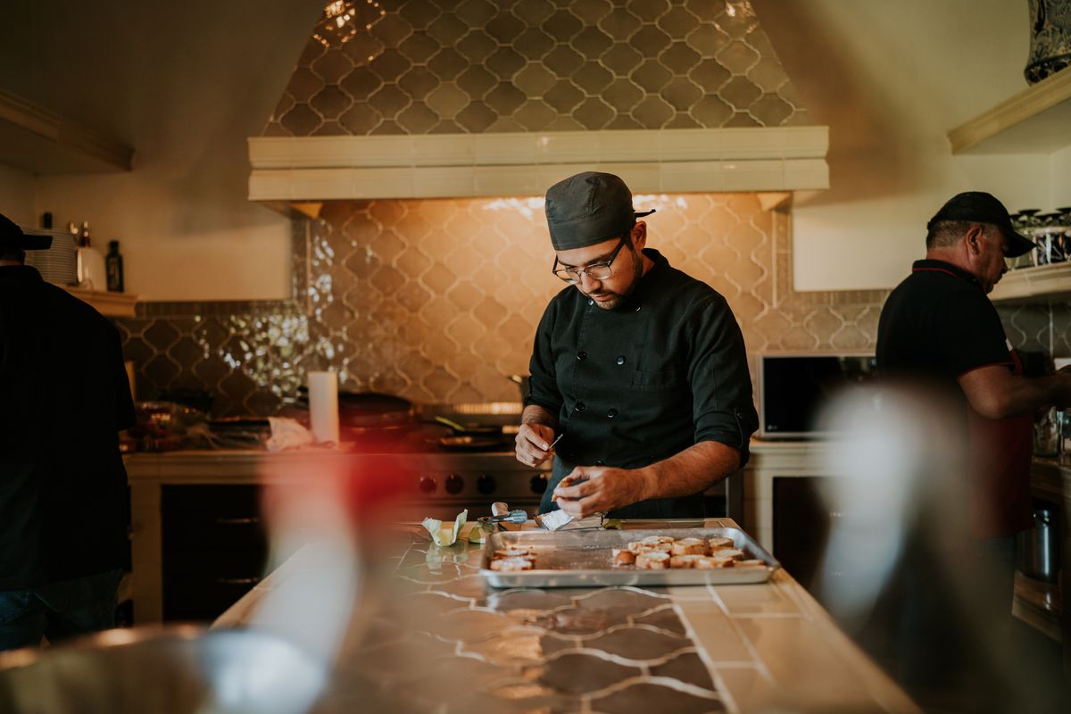 Chef plating a dish in a professional kitchen