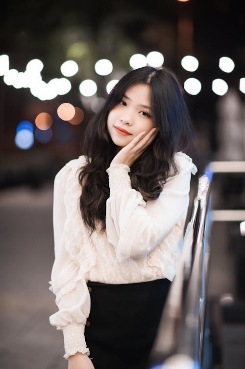 Young Elegant Woman Standing Outside in the Evening