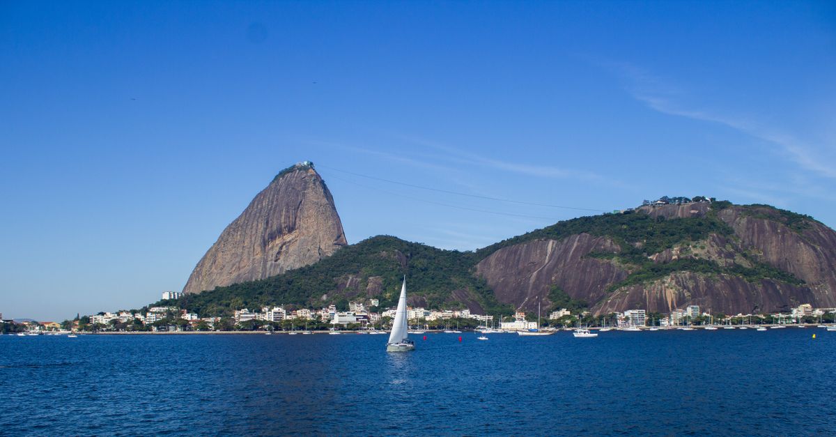 Scenic view of Sugarloaf Mountain with sailboats on a sunny day in Rio de Janeiro, Brazil.