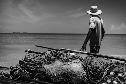 Fisherman in Hat on Sea Shore