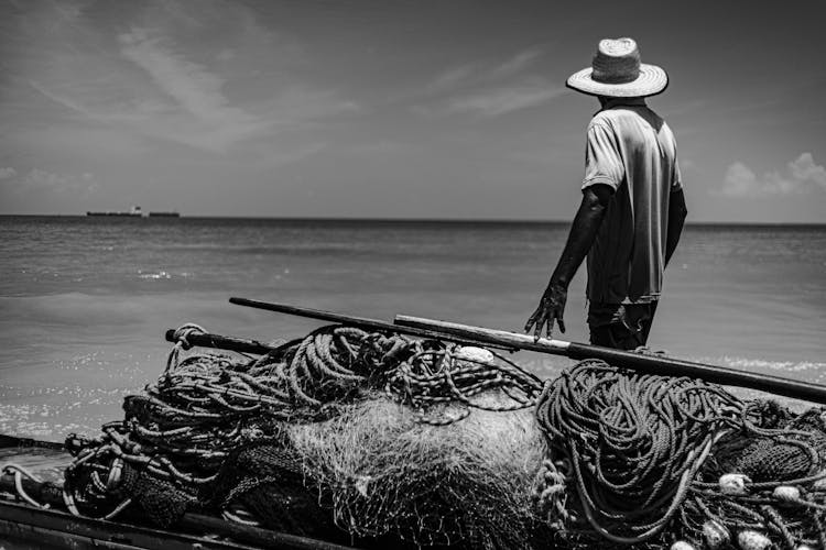 Fisherman In Hat On Sea Shore