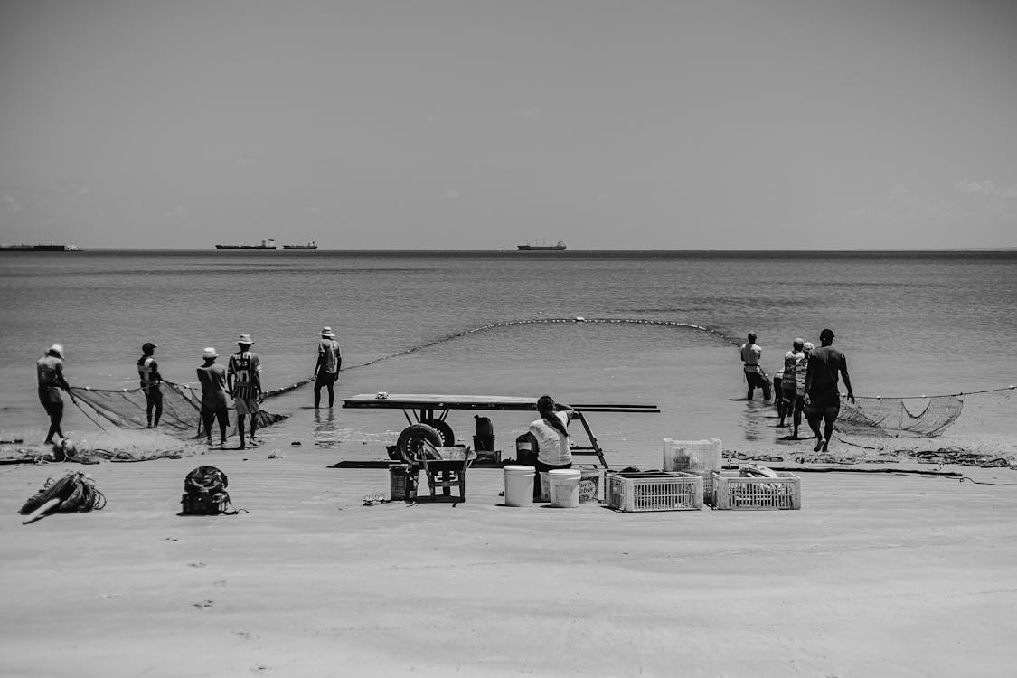 Fishermen Preparing Nets at a Beach