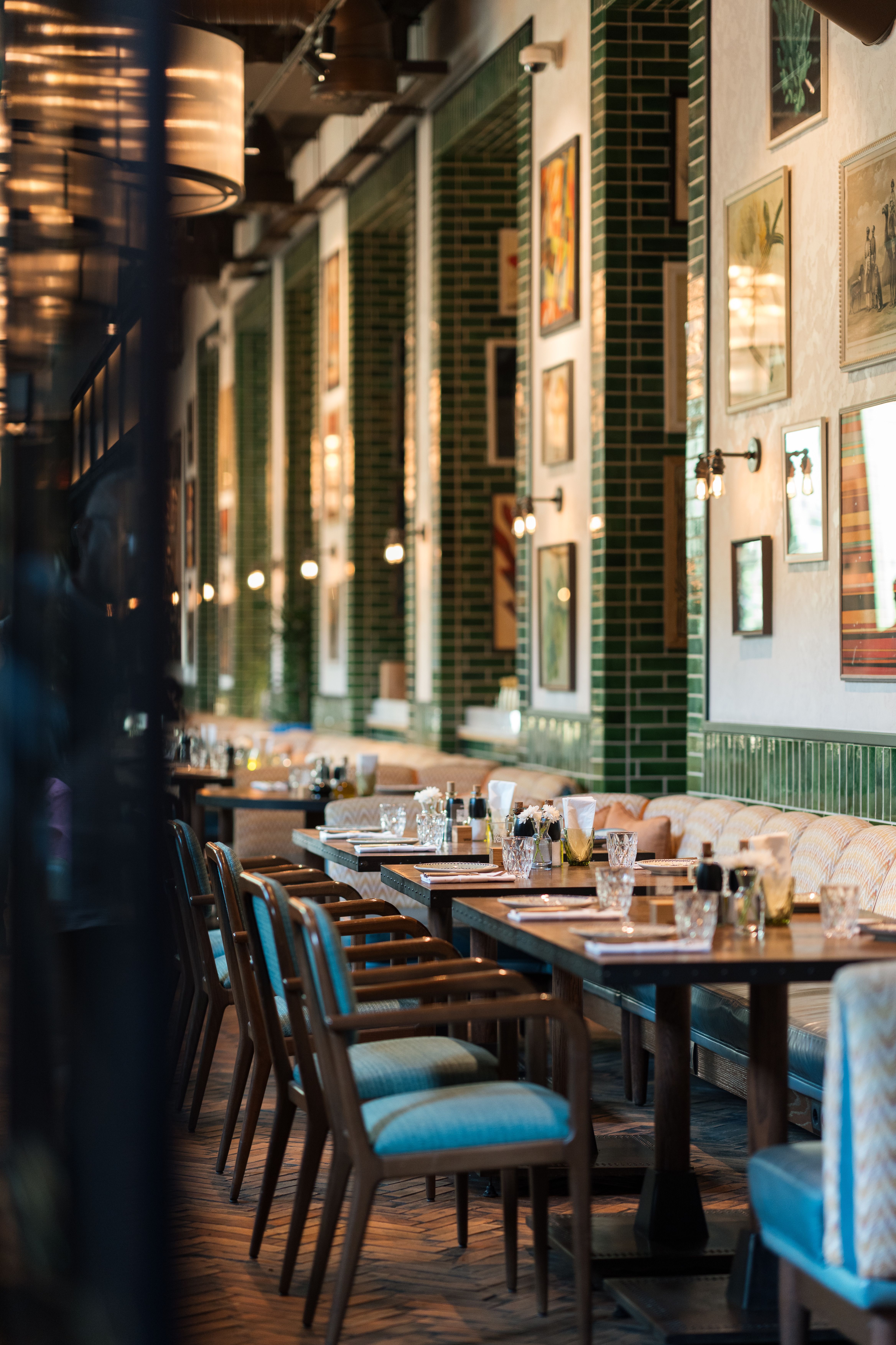 Stylish restaurant setting featuring elegant tables, chairs, and wall decor.