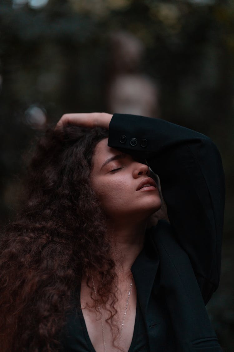 Woman With Neckline Top Holding Arm On Face