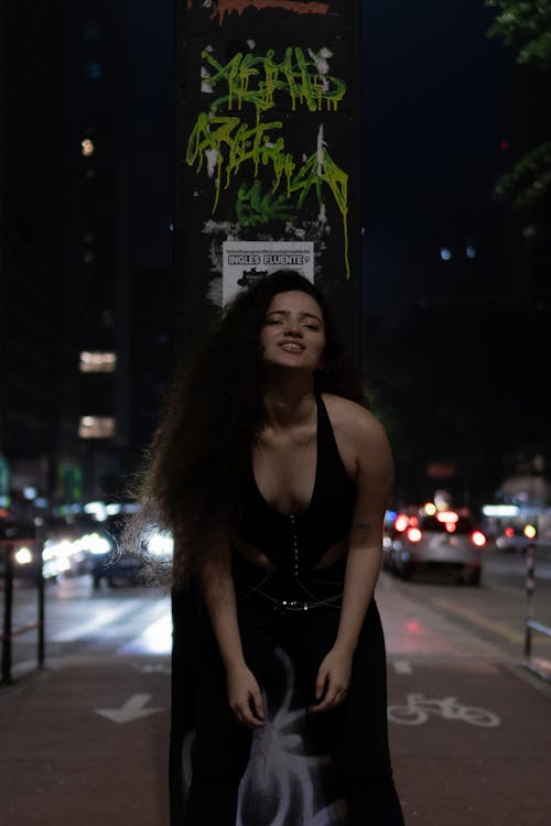 Brunette Woman Posing on a Street at Night