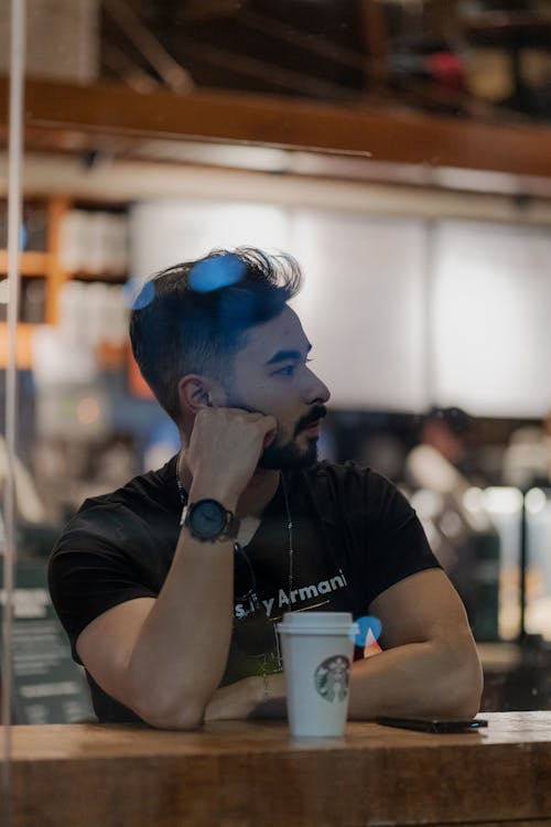 Man Sitting in a Coffee Shop