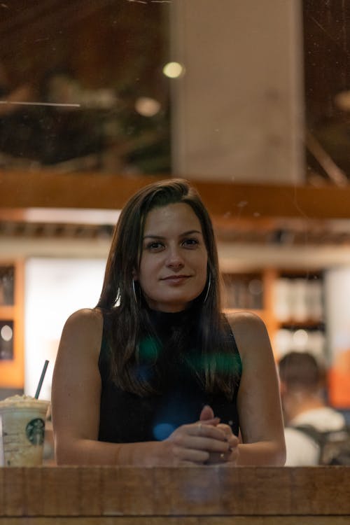 Brunette Woman Sitting in a Coffee Shop