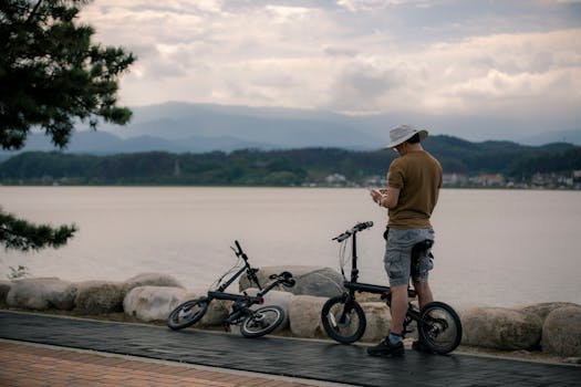Man on bike enjoys serene view of Gyeongpo Lake, South Korea.