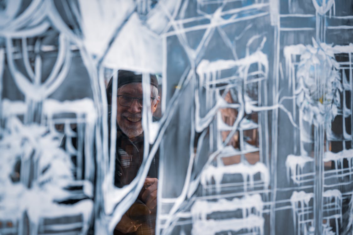 Elderly Man Among Ice Sculpture