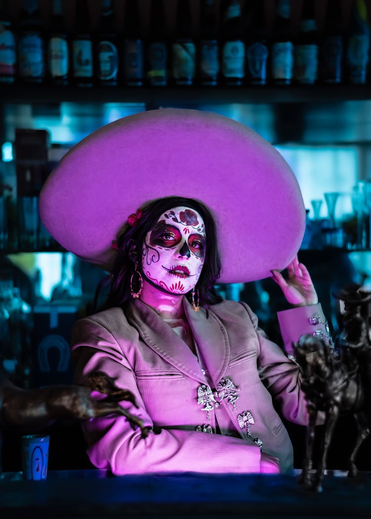 Purple Light On Woman In Hat And With Painted Face As Catrina