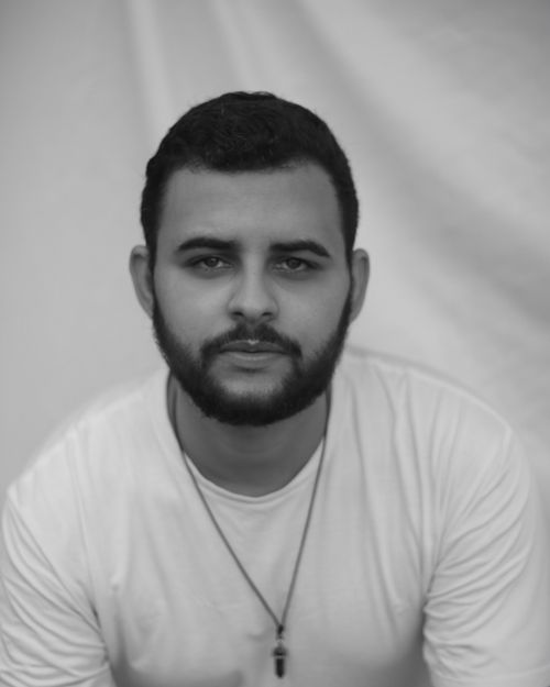 Free Thoughtful black and white portrait of a young bearded man in a white shirt. Stock Photo