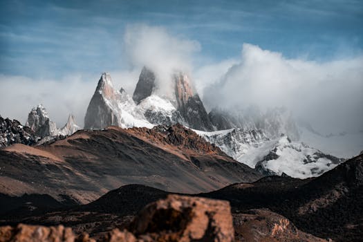 Breathtaking mountain landscape of Fitz Roy, El Chalten, with dramatic clouds and snow.