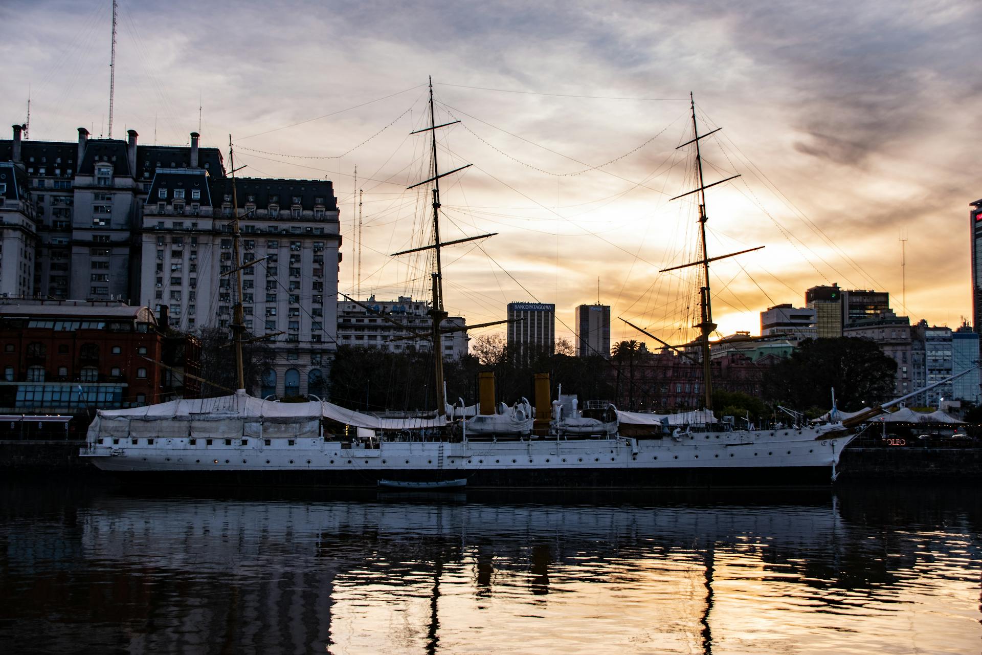 Historic training ship ARA Presidente Sarmiento moored in Buenos Aires during sunset.