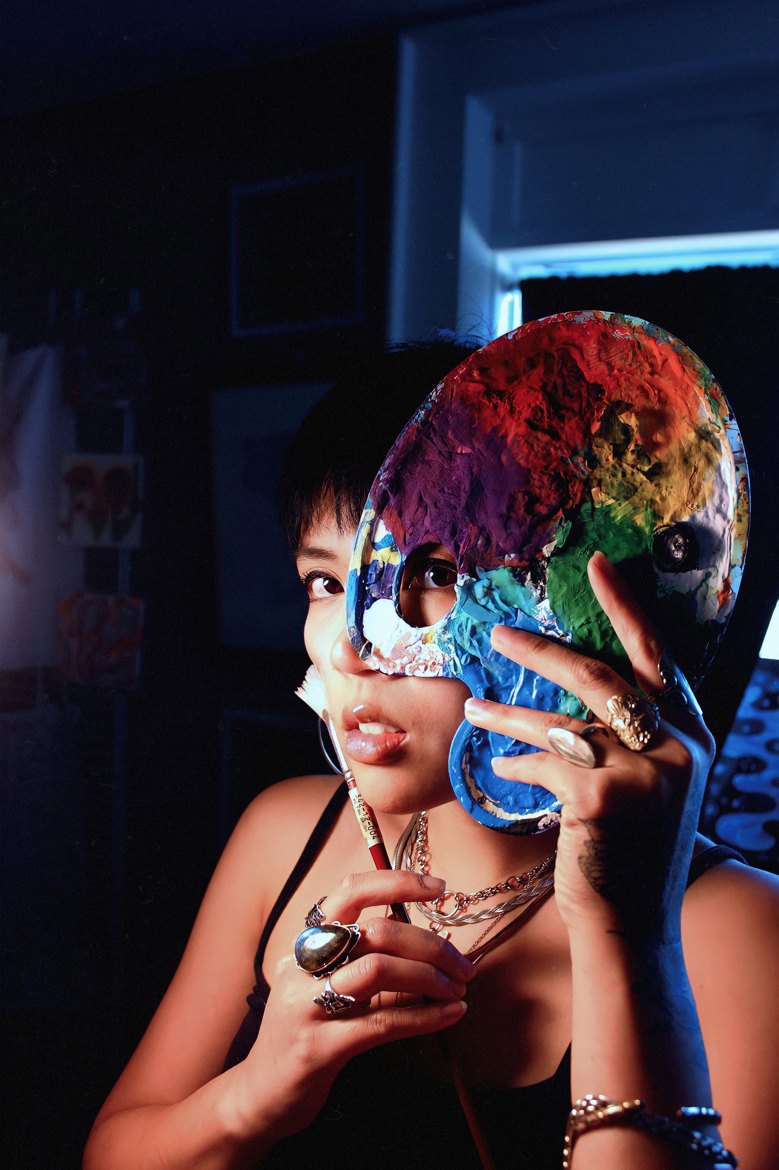 Portrait of a Young Woman Holding a Color Palette · Free Stock Photo